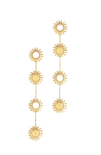 Load image into Gallery viewer, A pair of gold-toned drop earrings featuring five sunburst motifs connected by thin gold bars, set against a solid light gray background.
